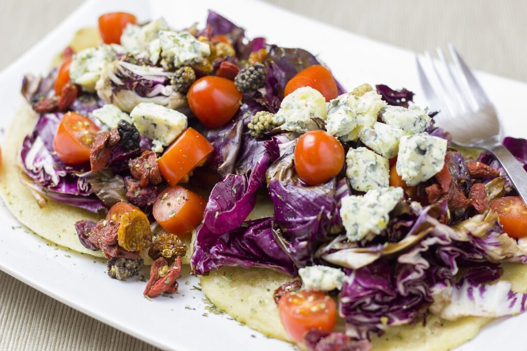 Crumbled Roquefort on salad with walnuts and honey drizzle.