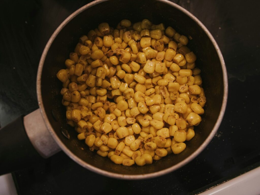 Seasoned corn on the stovetop overhead.