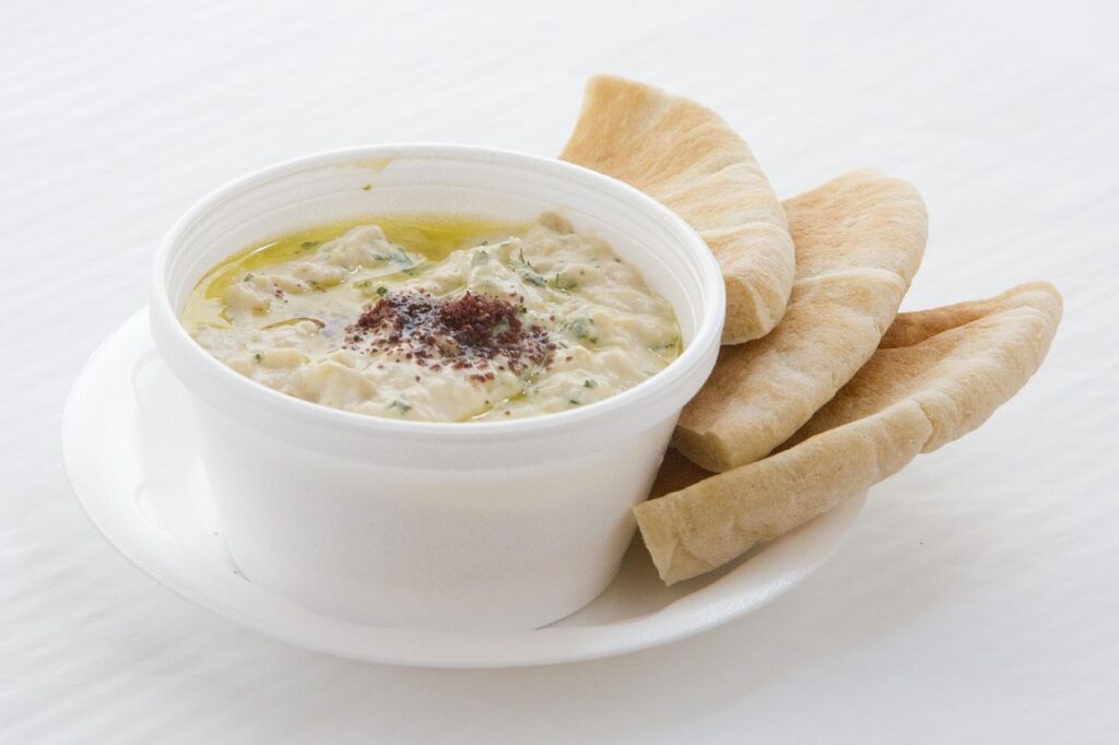 Hummus cups with pita chips and veggie sticks
