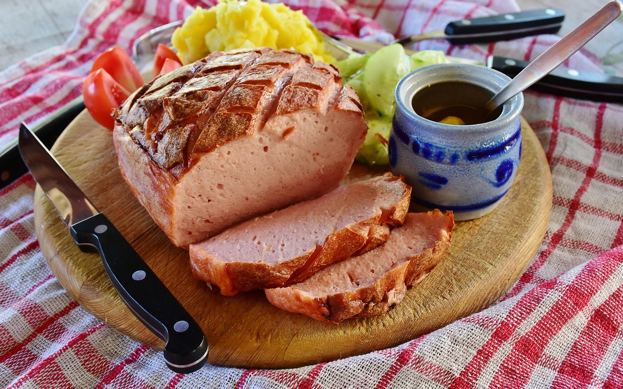 Sliced meatloaf with ketchup glaze on a serving platter.