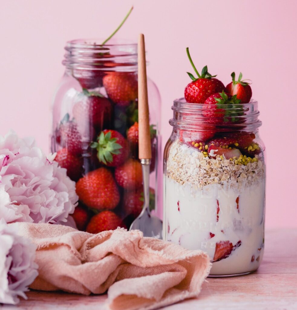 Jar of overnight oats topped with fresh fruit.
