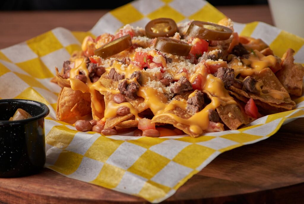 Baked nachos with melted cheese, beans, and toppings.