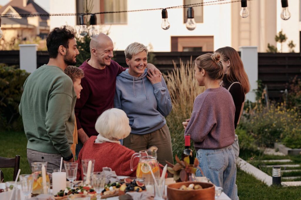 A Family Standing Near Table with Food