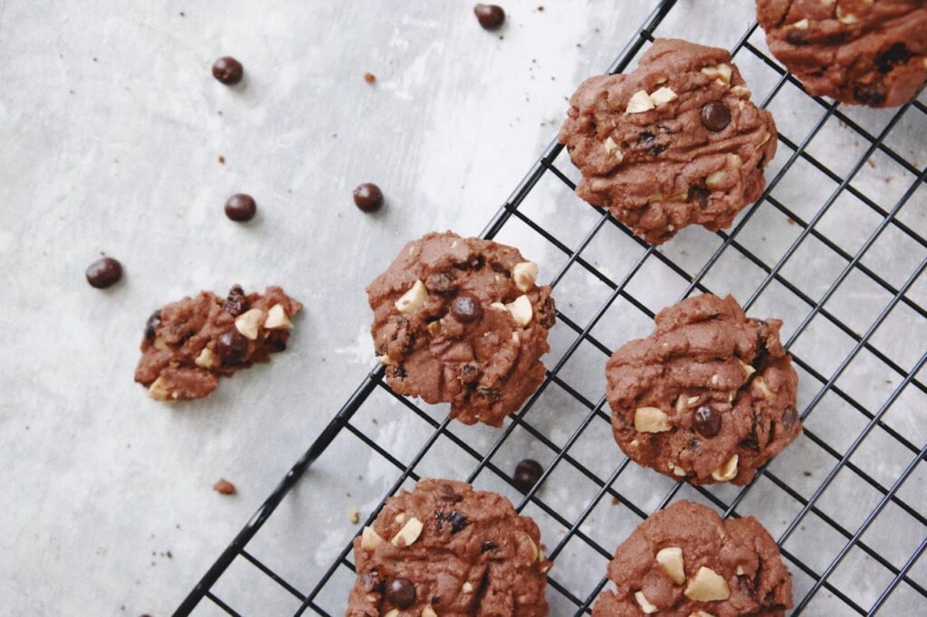 Chocolate chip cookies cooling on a wire rack.