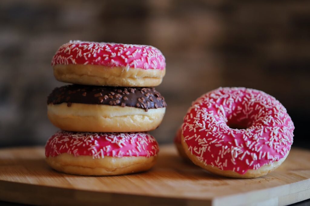 Stack of Colorful Frosted Doughnuts with Sprinkles