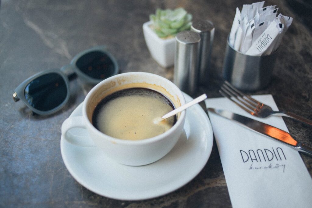 black coffee cup near to salt