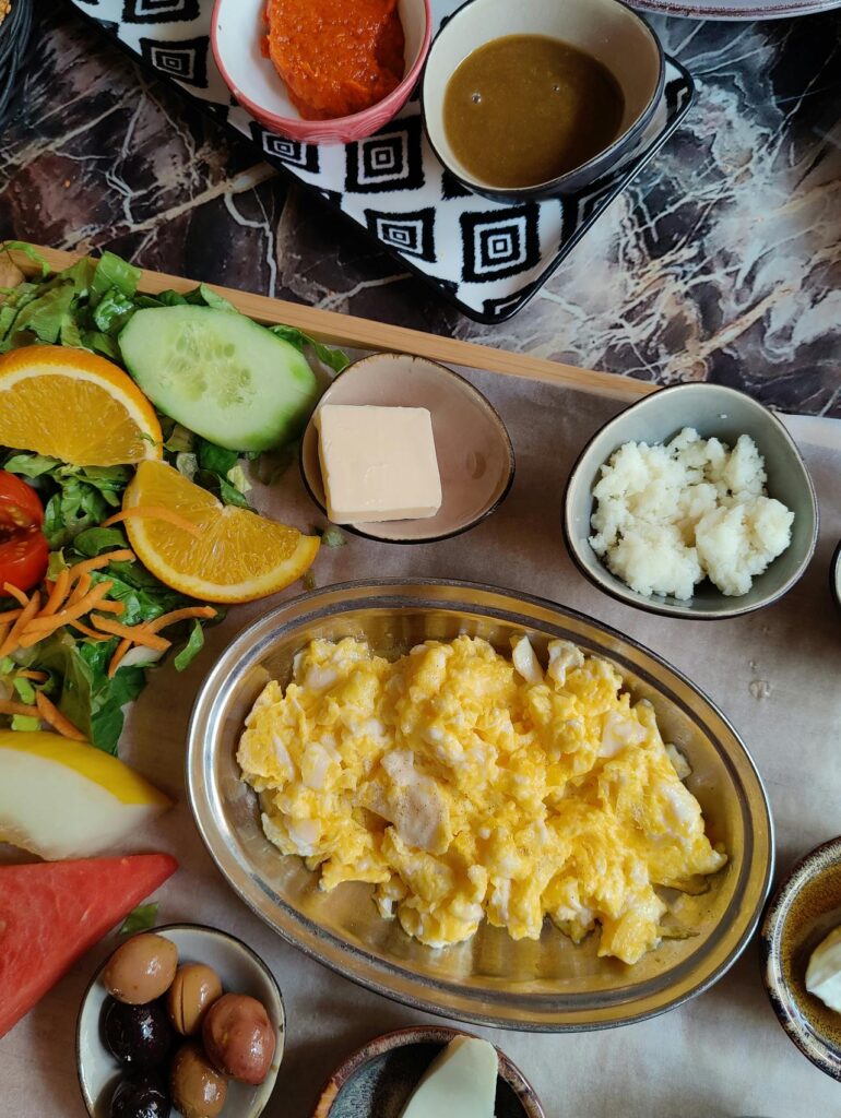 Scrambled eggs bulked with cheese and veggies, served family-style.