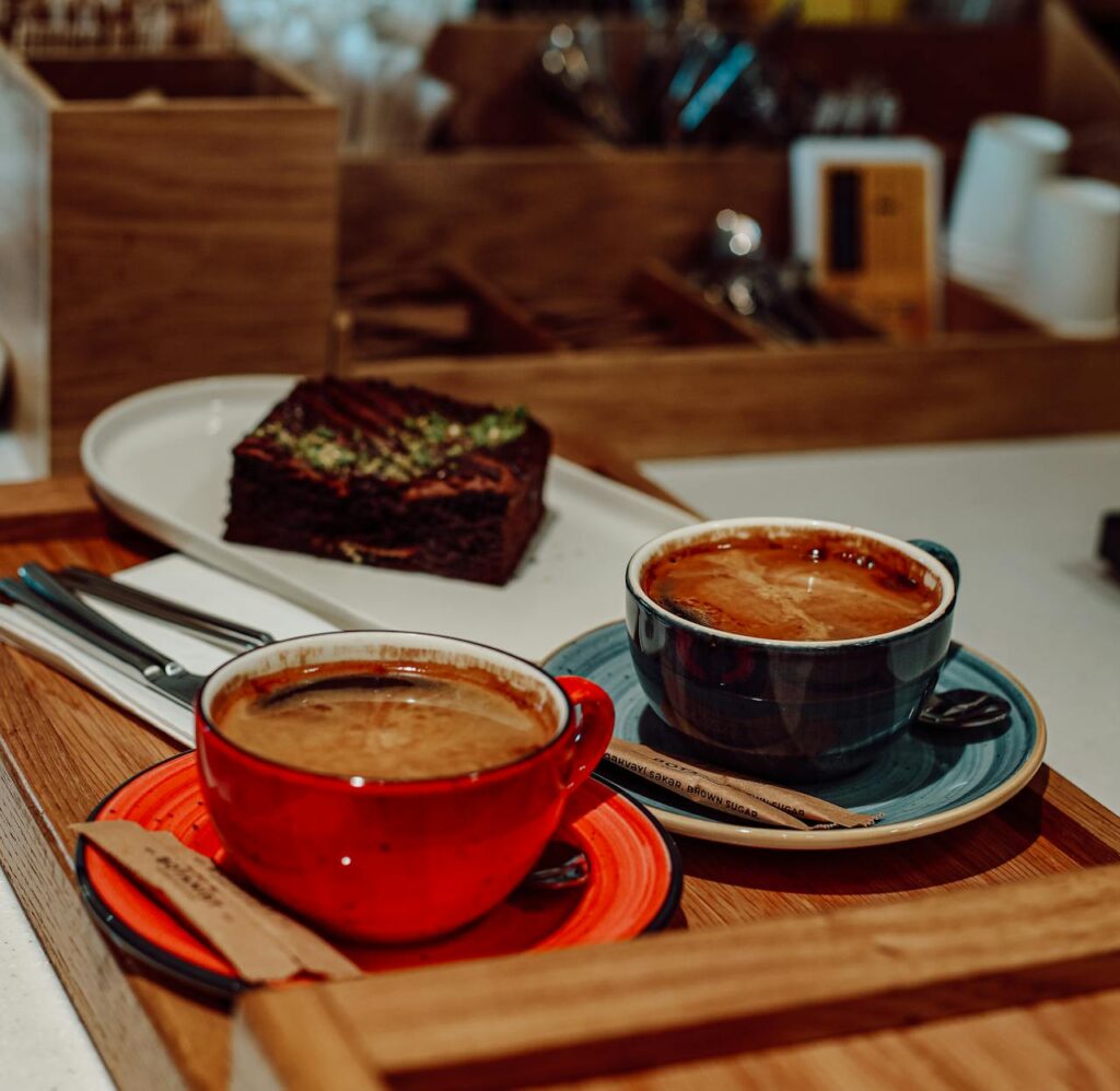 Cups of Coffee and Cake behind