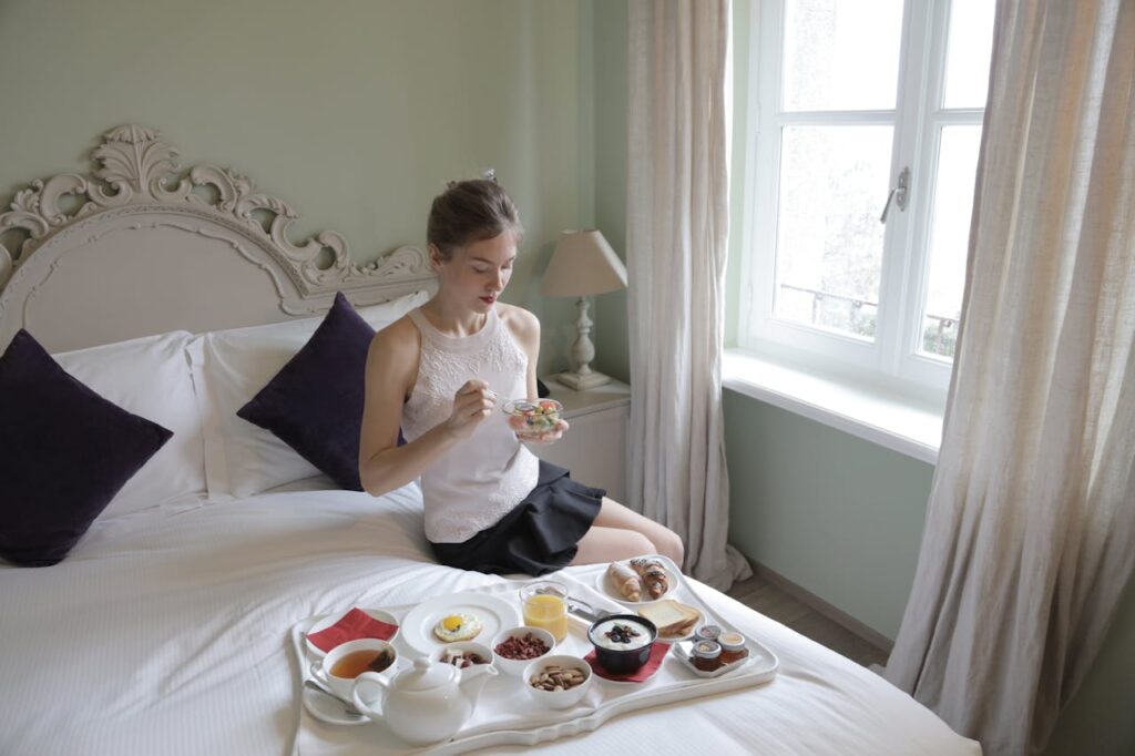 woman having breakfast on bed