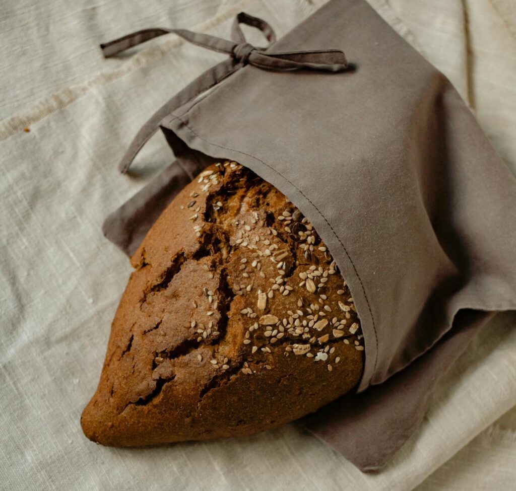 Bread in a Fabric Bag Lying on Linen Fabric
