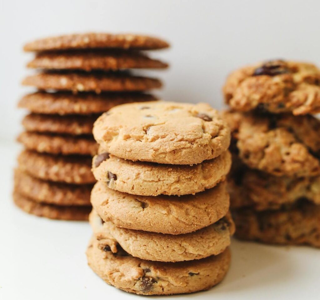 Chewy molasses cookies stacked on a plate,