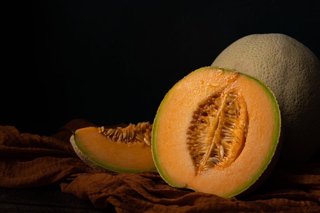 Close-up of cantaloupe skin showing golden undertones and netting.
