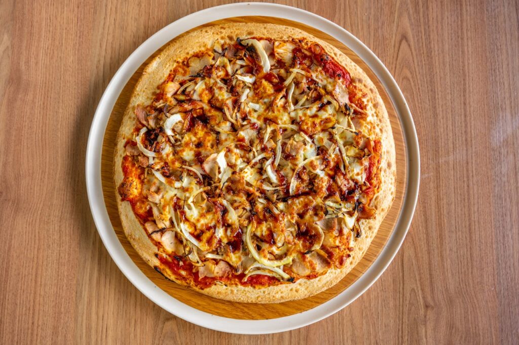 Delicious BBQ Chicken Pizza on Wooden Table