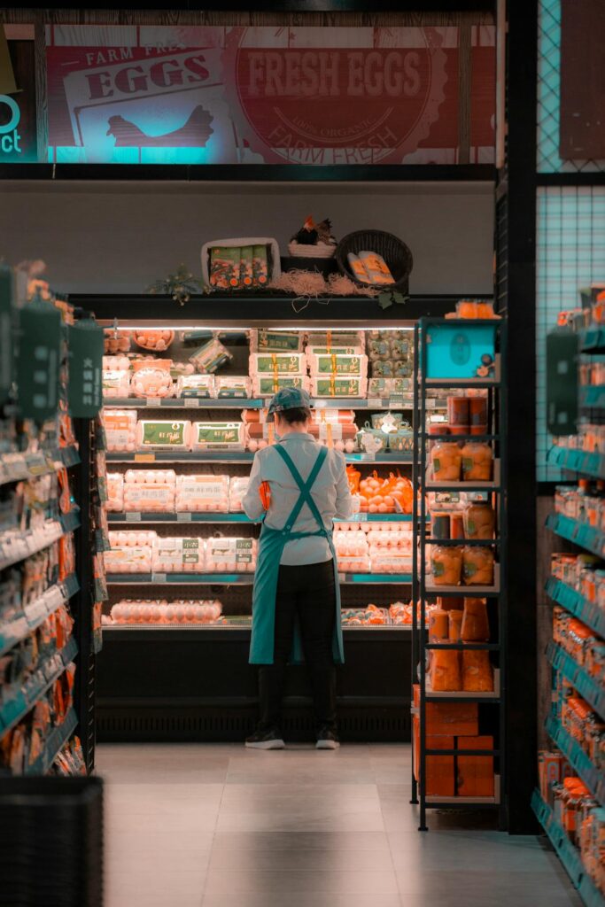 Employee of A Supermarket Standing Beside Chilled Products