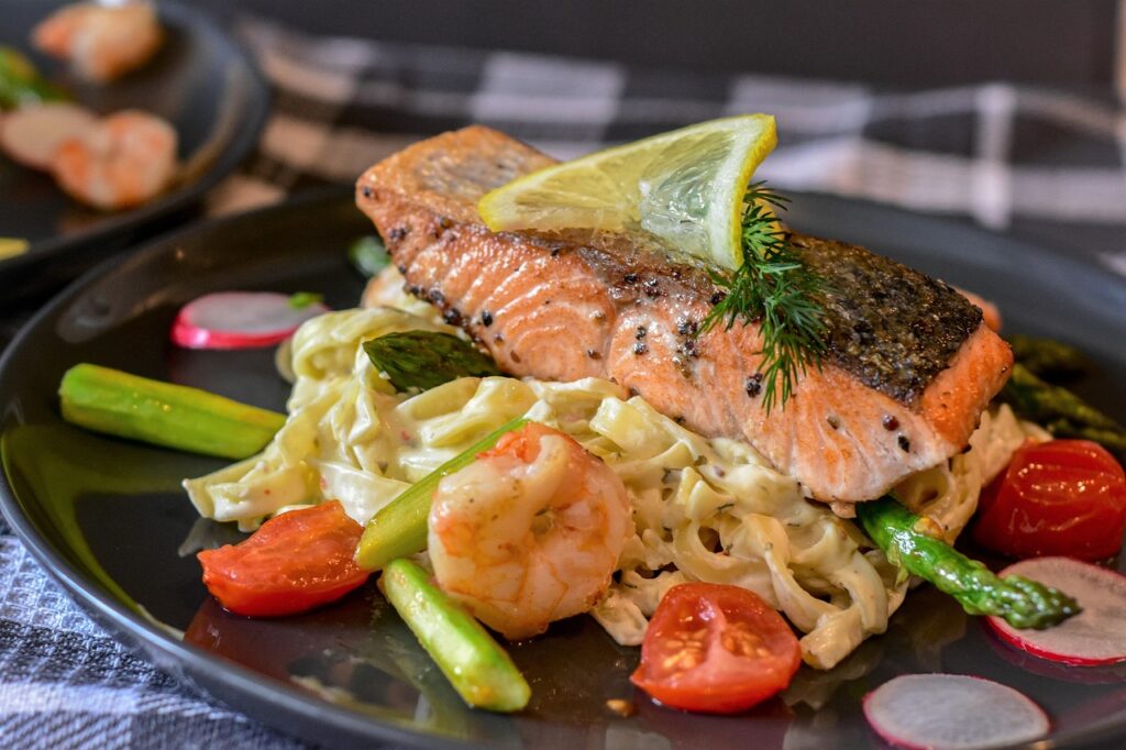 Salmon fillets with roasted asparagus and lemon slices for brightness.