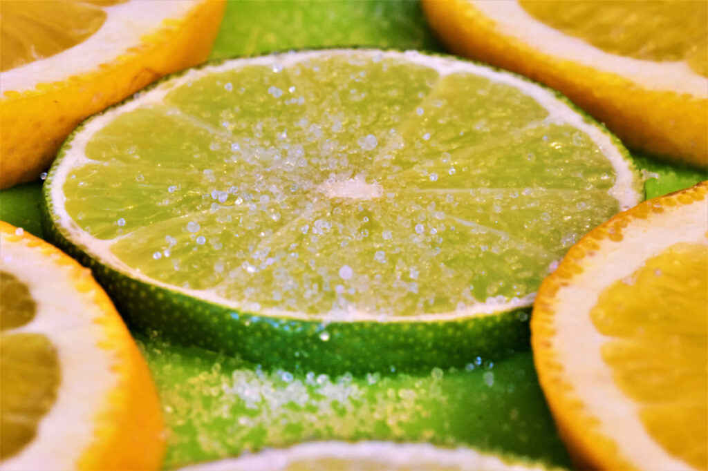 The lime was sliced on a green sideboard with orange sliced as well.And sprinkle with salt.