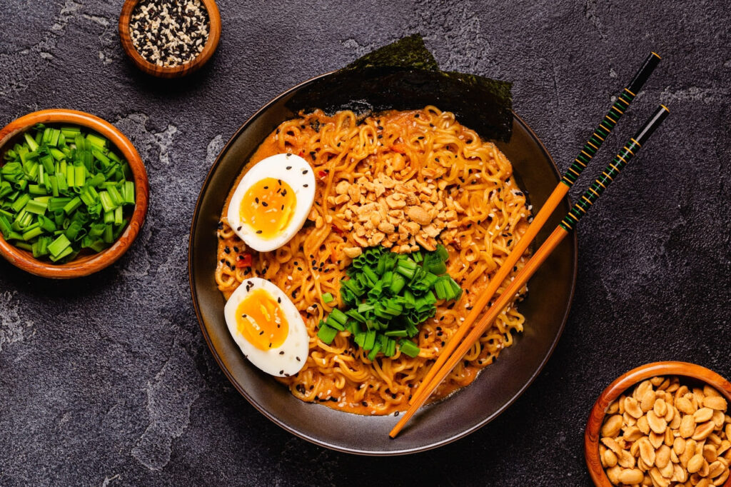Korean style instant noodle, Shin Ramyeon with peanut and egg, top view.