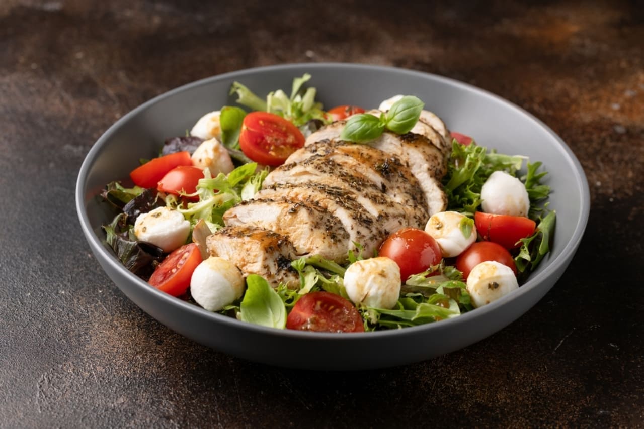 Chicken caprese salad with tomato, mozzarella and balsamic dressing