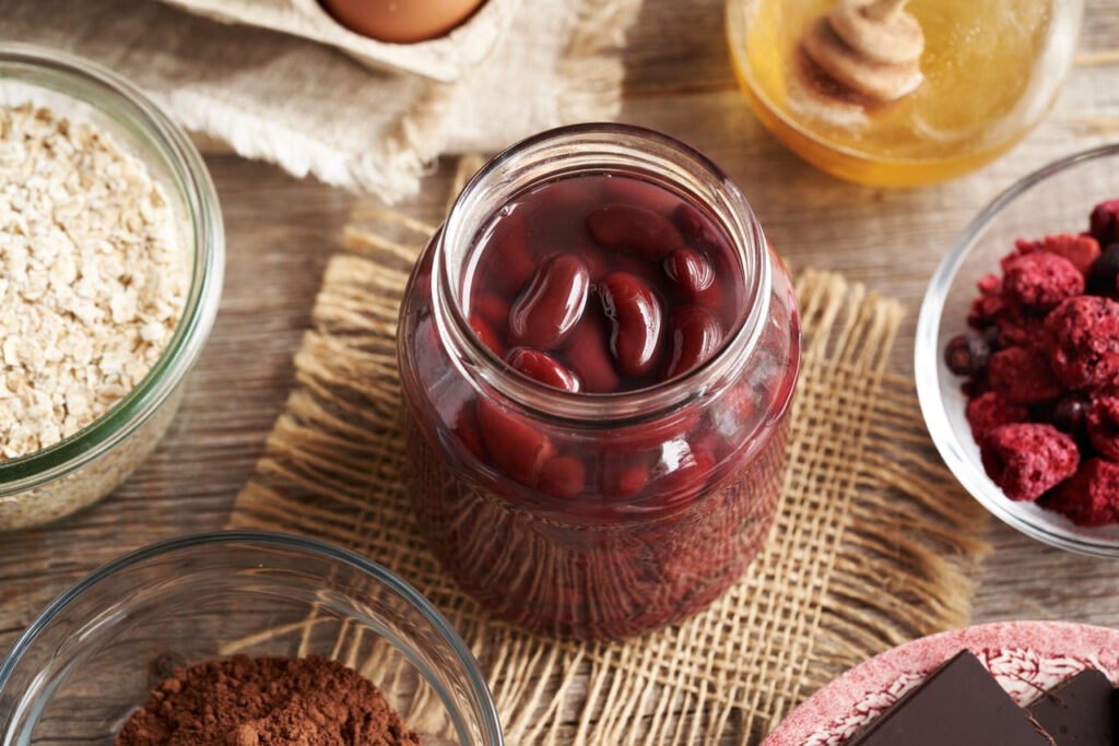 A jar of red kidney beans, oat flakes, eggs, cocoa and honey - Ingredients for baking homemade gluten-free brownies