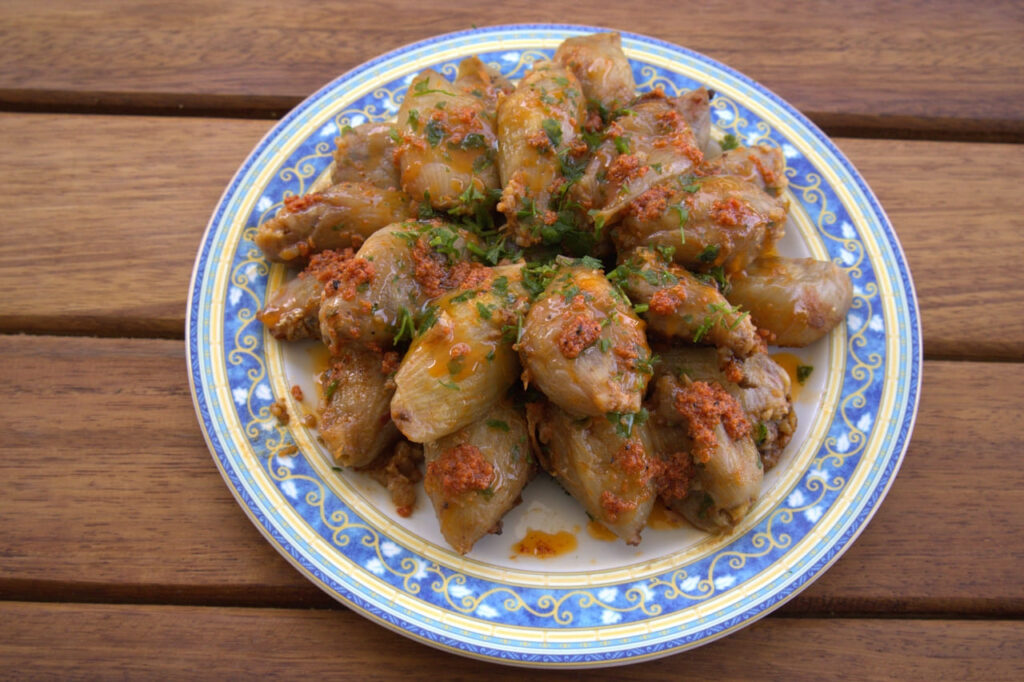 Stuffed onion dish on wooden table. One of the traditional Turkish dishes is stuffed onion dish.