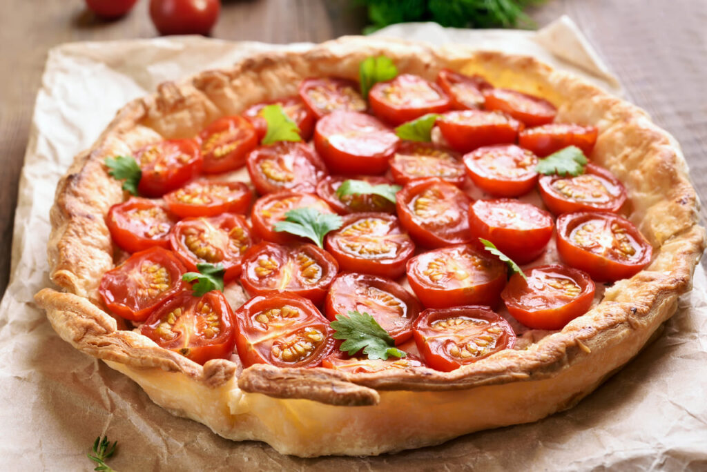 Tomato pie on baking paper, close up view