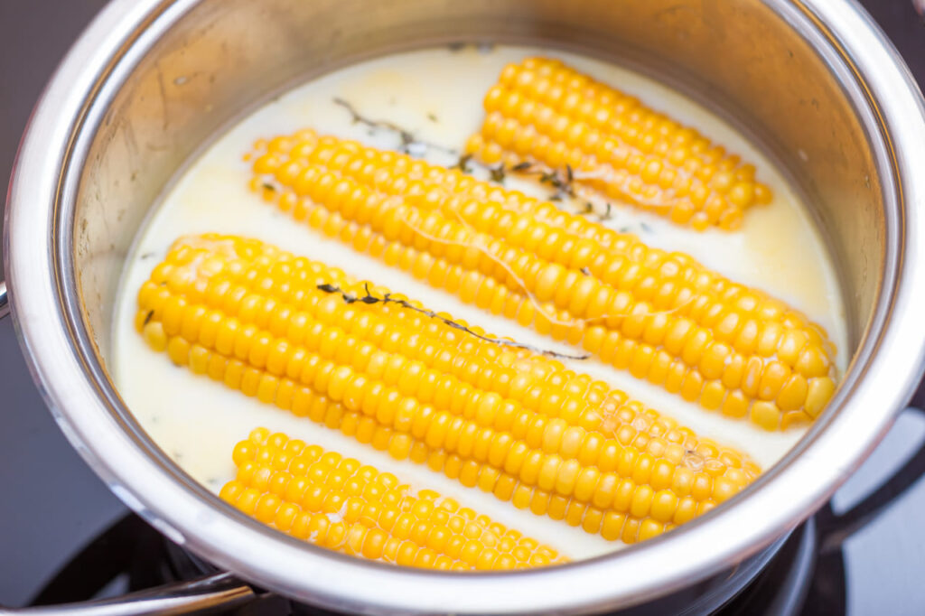 corn cooked in milk in a saucepan.pot of boiled corn and milk