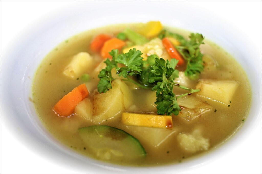 Colorful soup or stew in a pot, loaded with diced vegetables 