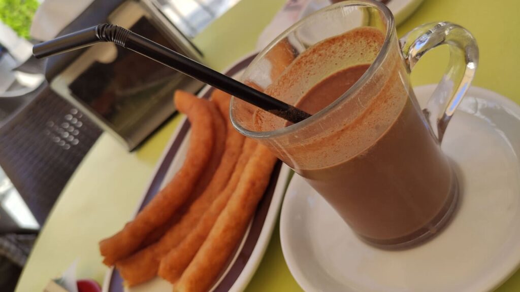 Traditional Spanish dessert churros with sugar and chocolate