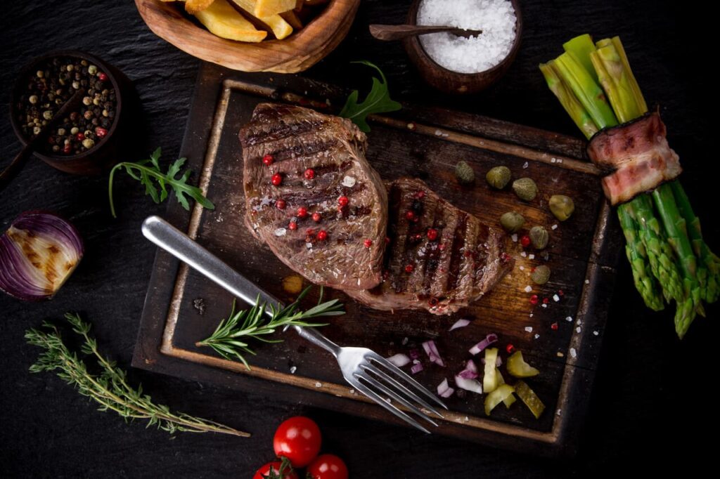 Delicious beef steak on wooden table, close-up