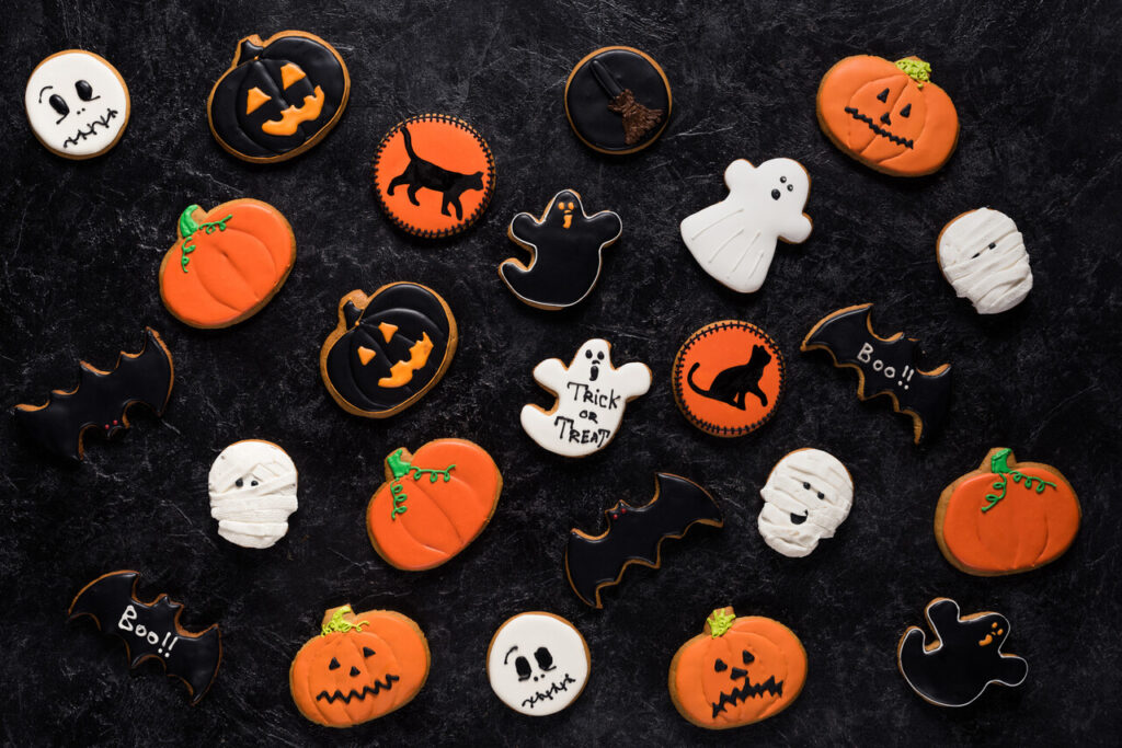 top view of composition of homemade halloween cookies on black marble table