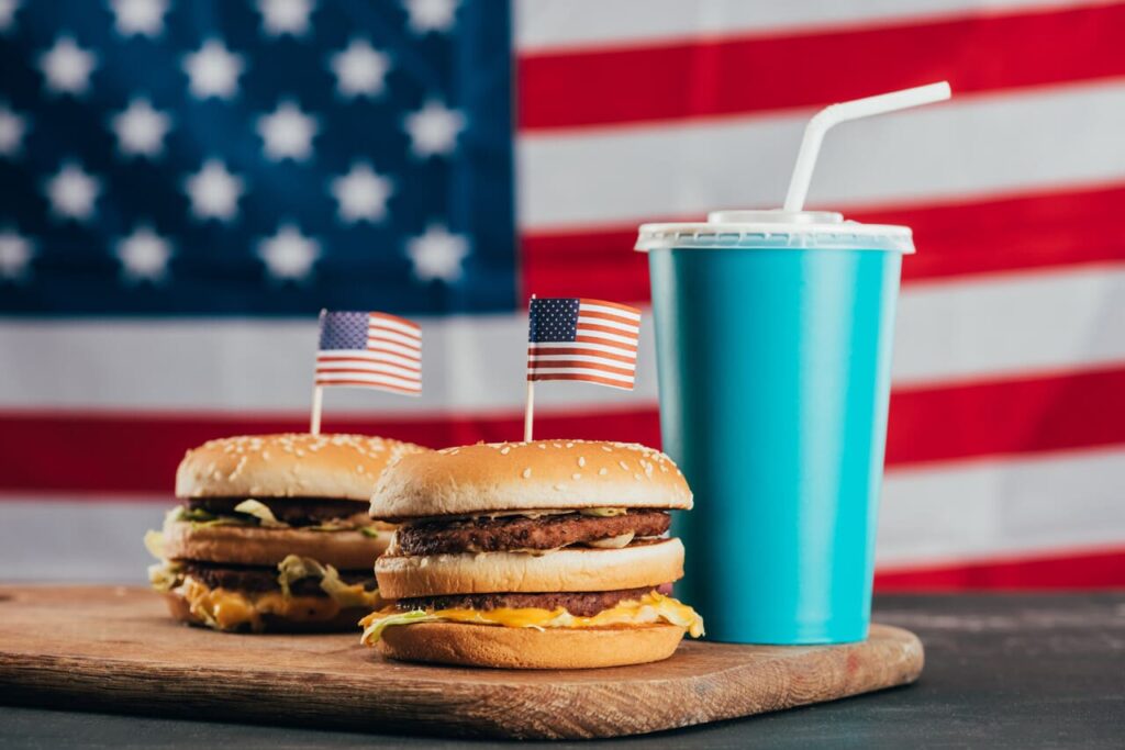 American fast-food meal like a tray with a large burger, fries, and soda