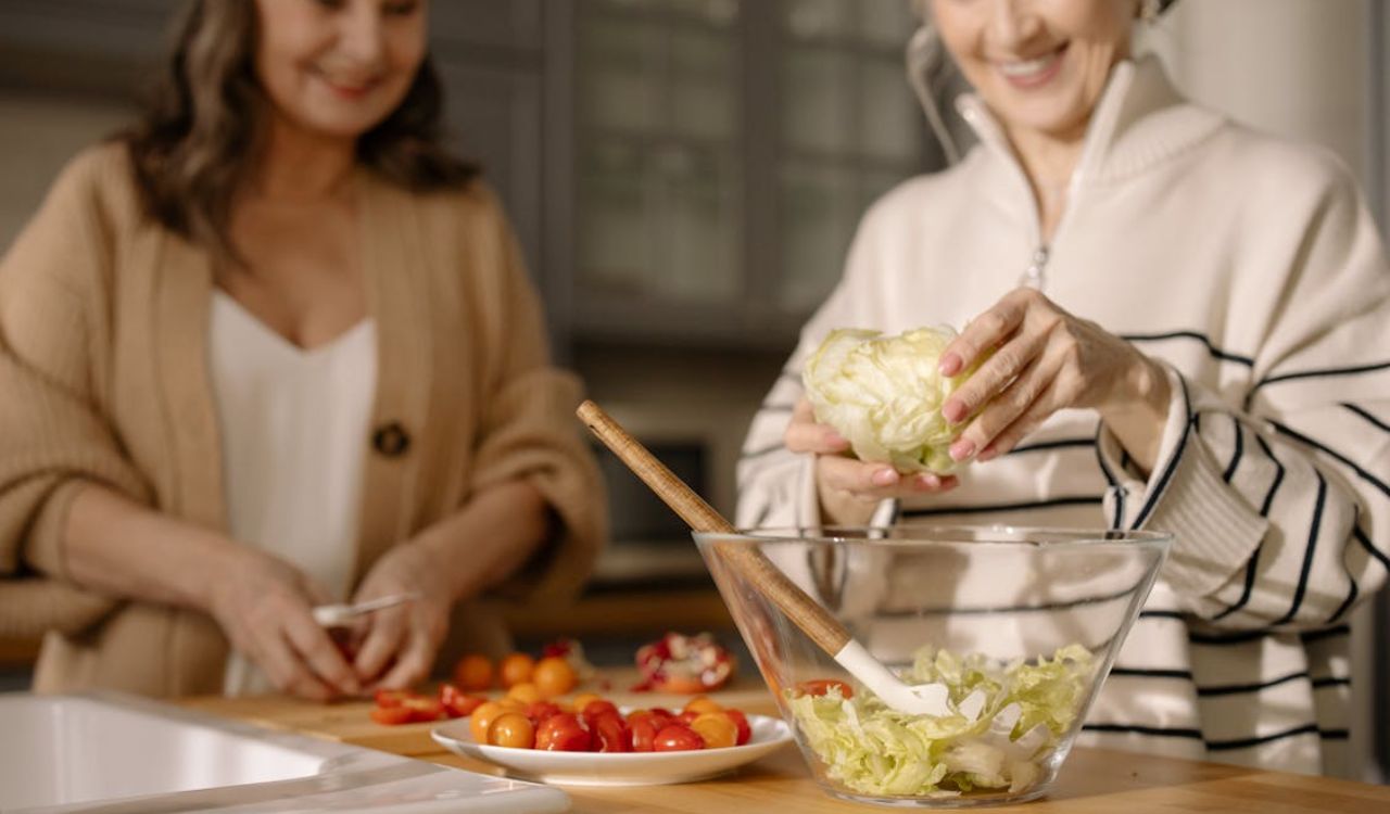 An Elderly Women Preparing Fresh Salad in the Kitchen