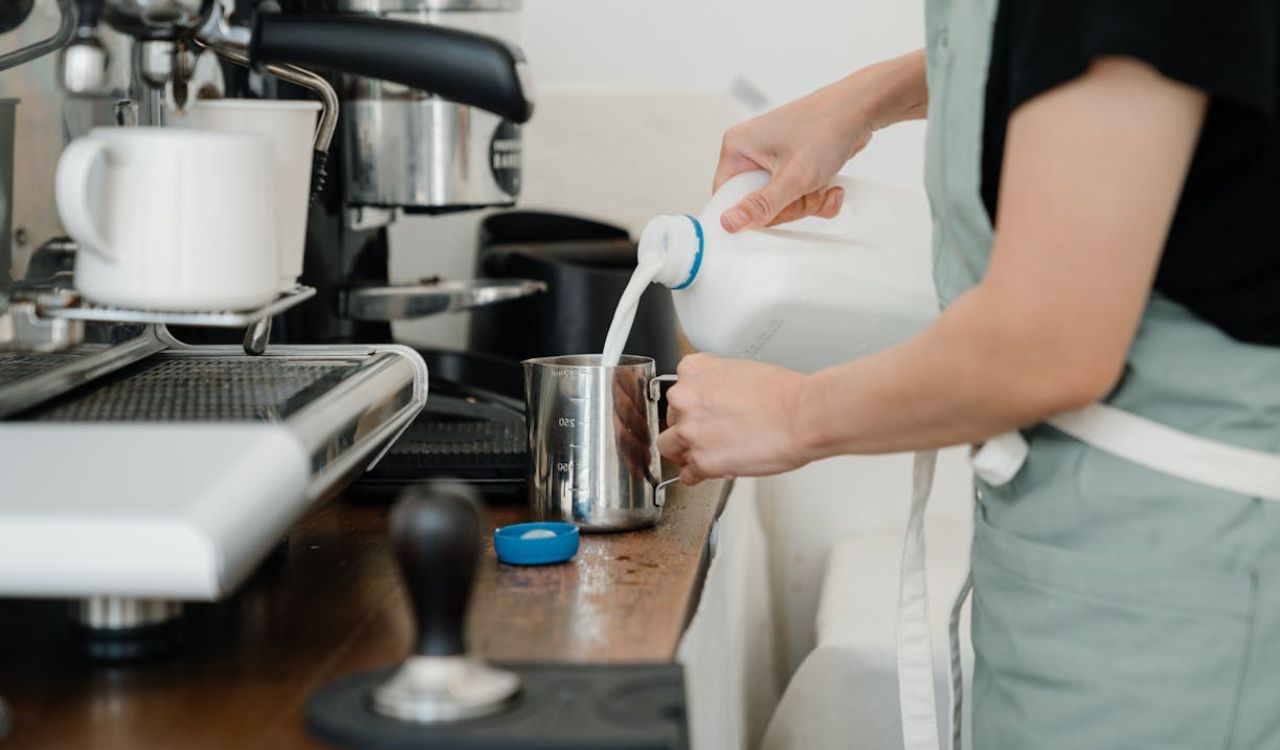 Barista pouring milk