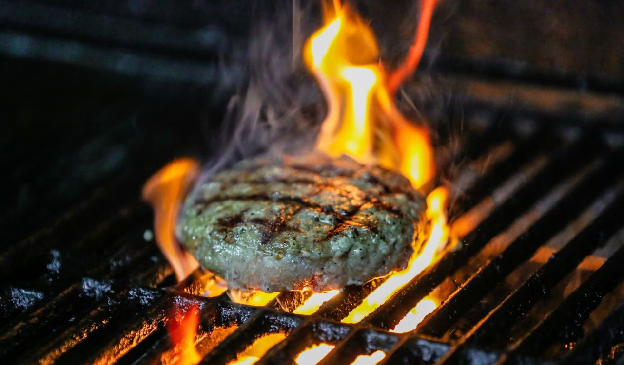 Hamburger cooking on grill