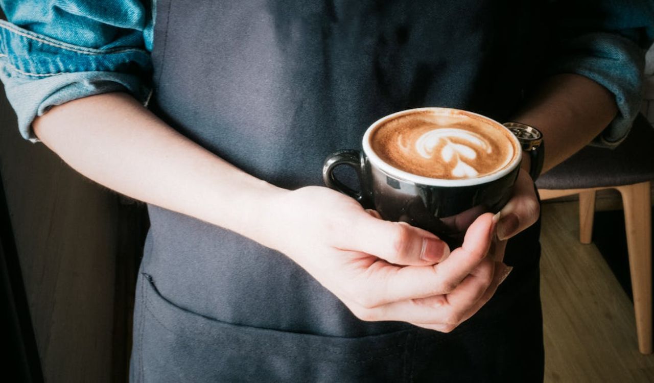 Holding a Cup of Coffee