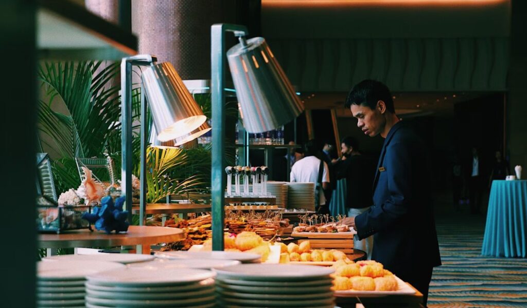 Man pick some food at buffet table