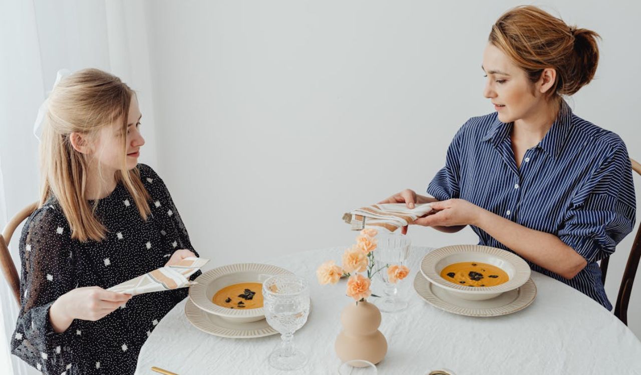 Mother and daughter eating soup