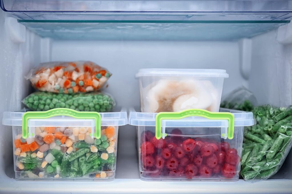A neatly organized freezer with labeled containers of food.