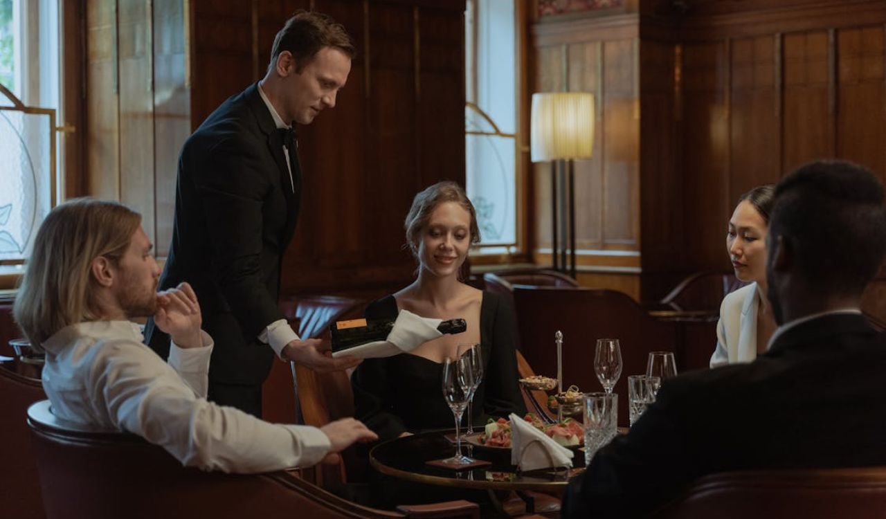 Waiter serving drink