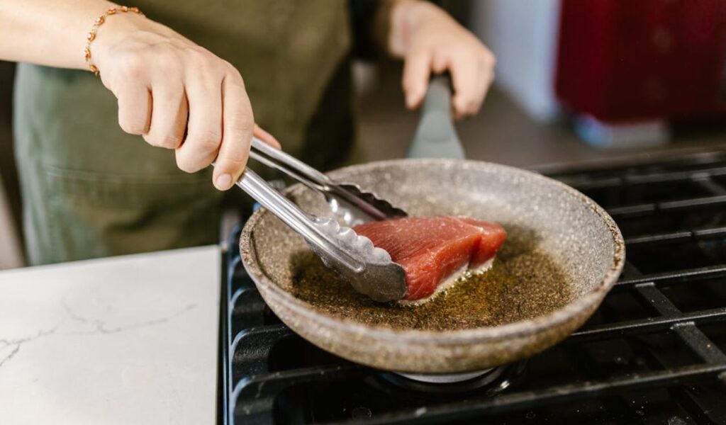 Woman cooking tuna
