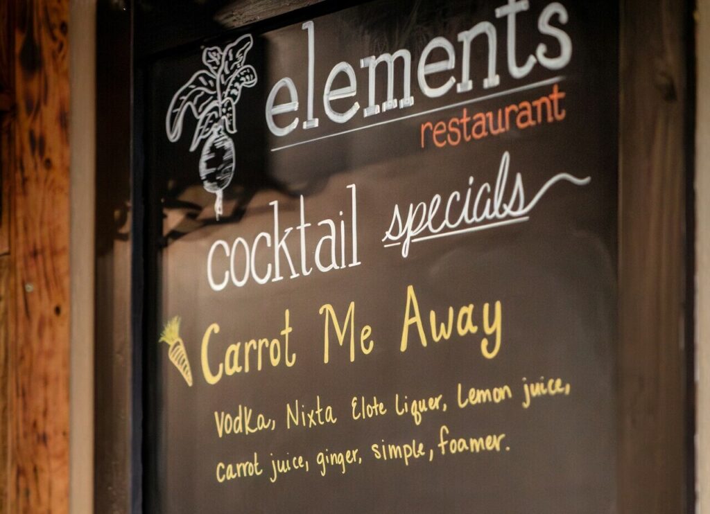 A cocktail menu with prices visible.