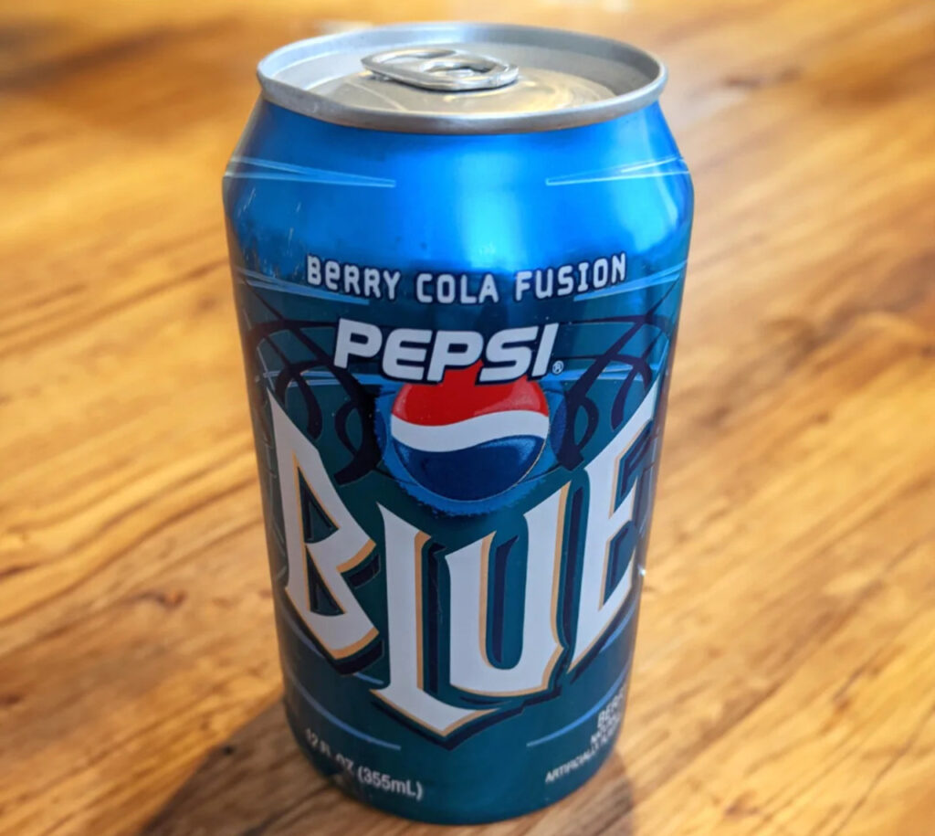 Pepsi Blue first hit shelves in 2002 but was discontinued just two years later. In 2021, Pepsi decided to bring it back for a limited summer run, hoping to capture both nostalgia and curiosity. The bright blue soda caught plenty of attention at gas stations and grocery stores, but the novelty wore off quickly. Many people found it too sweet, almost like liquid cotton candy. After its short summer return, it disappeared again, leaving behind only the memory of its flashy color and one-season buzz.
