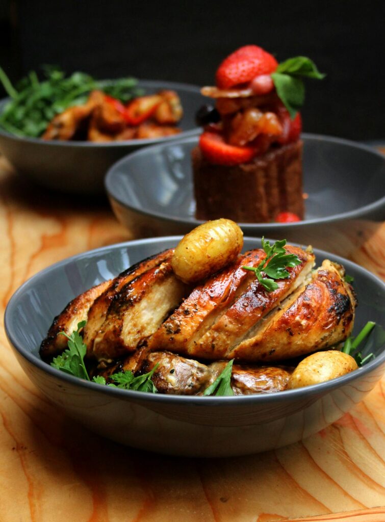 A plated chicken breast with garnish