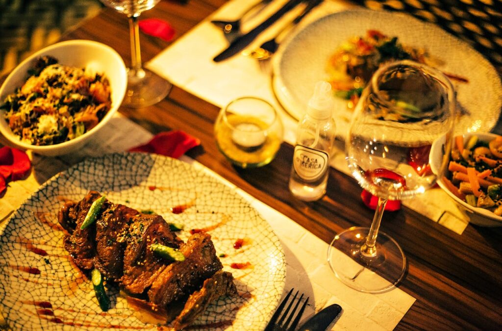 A dimly lit steakhouse table with a plated steak