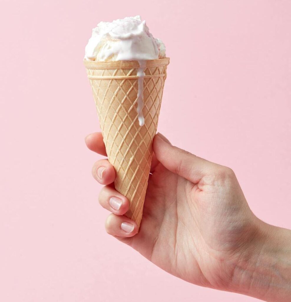 A classic waffle cone filled with vanilla ice cream