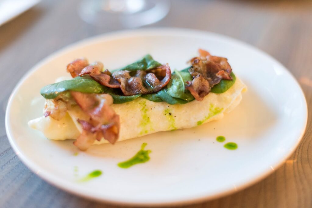 A stylish restaurant plate with a very small, artfully plated portion