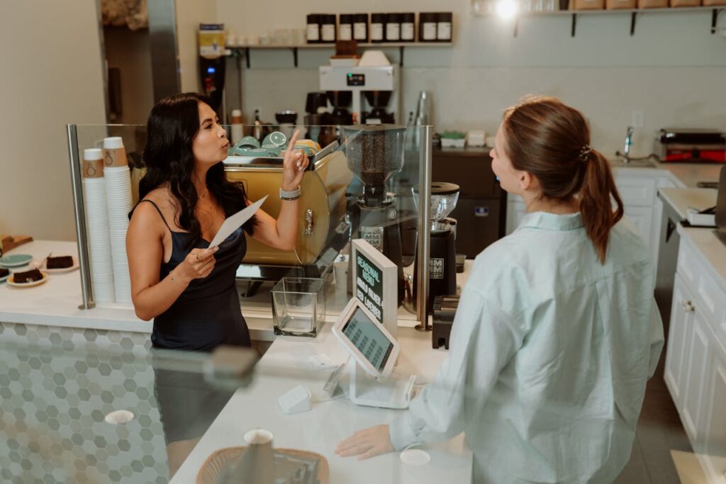 Customer pointing at the menu to clarify a drink.