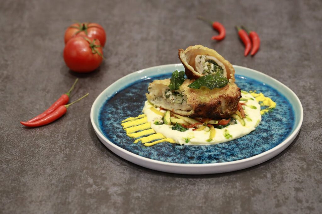 A small entrée portion plated artfully on a large plate.