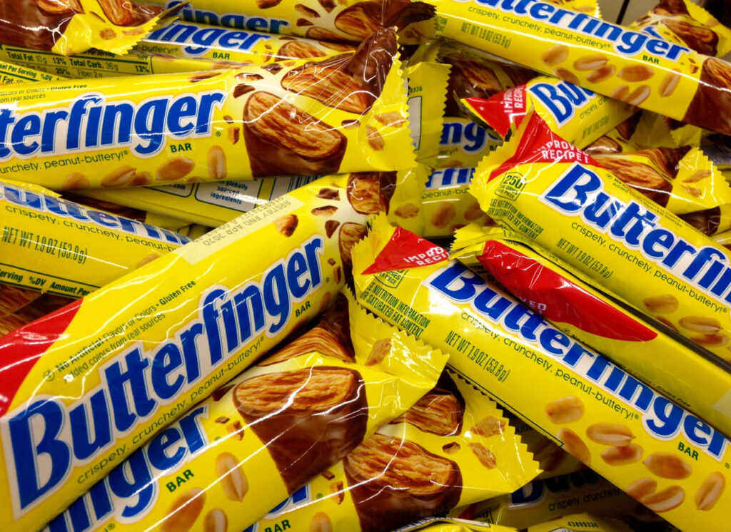 Butterfinger candy bars advertising an improved recipe are for sale in a bin
