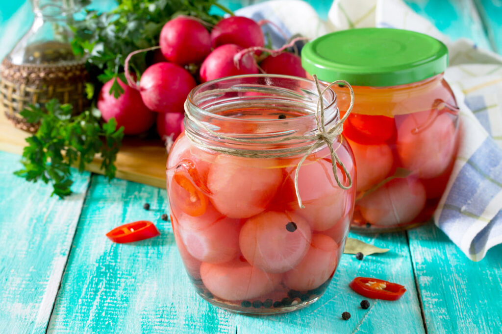 Vegetables, pickled radish and chili, with space for text.